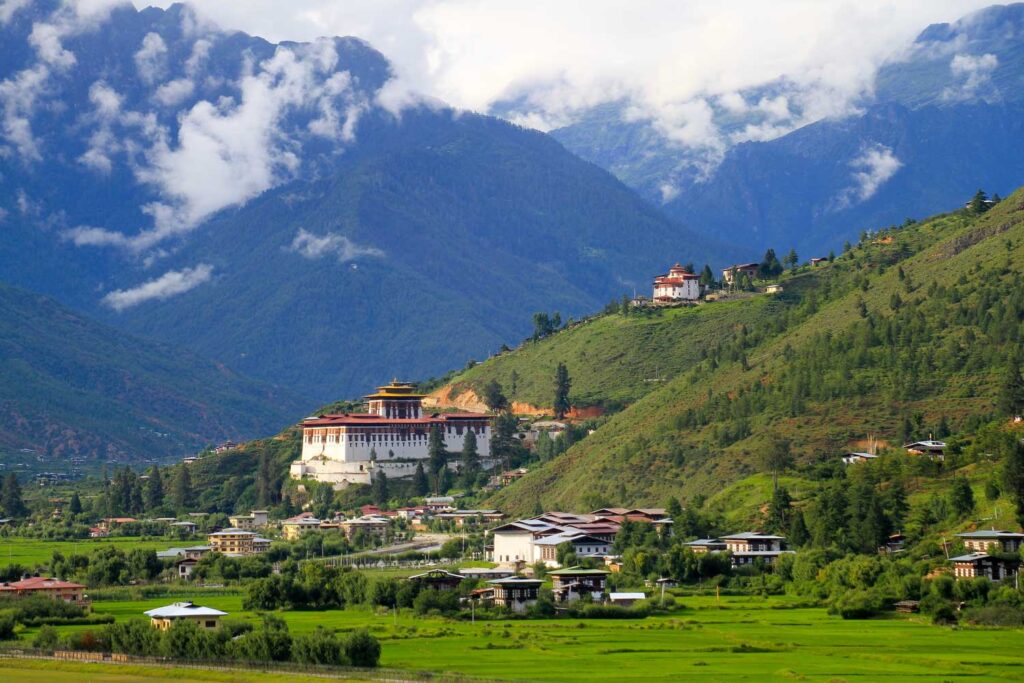 Paro Rinpung Dzong. Verdant valley surrounds Paro Rinpung Dzong, showcasing Bhutan's serene landscapes and heritage.