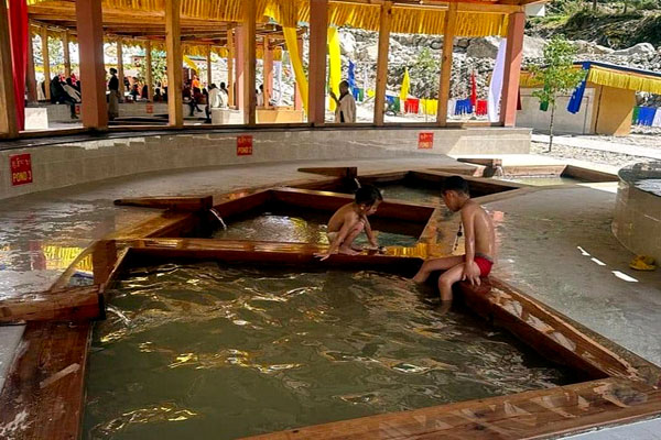 Children relaxing and enjoying the soothing hot spring bath, smiling and playful.