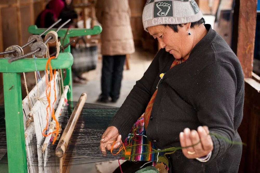 Women weaving traditional dress. Things to do in Bhutan