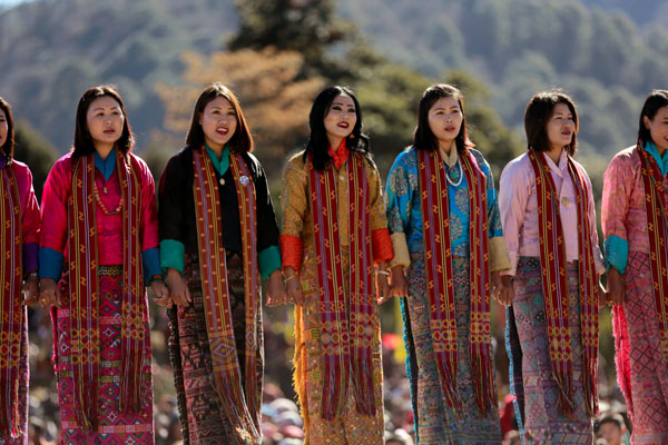 Attend a Traditional Cultural Performance. Bhutanese traditional dance showcases colorful local attire, graceful movements, and cultural storytelling.