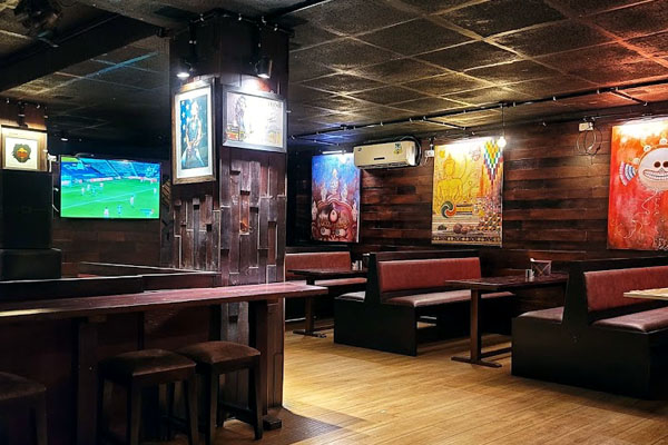 Explore Thimphu’s Nightlife. Mojo Park's vibrant interior features dynamic lighting, cozy seating, and artistic decor.