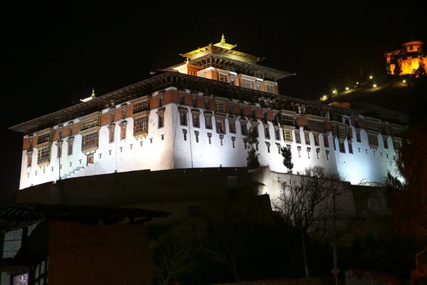 Take a Night Walk Around Paro Town. Paro Dzong and Ta Dzong illuminate Bhutan's night with majestic beauty.
