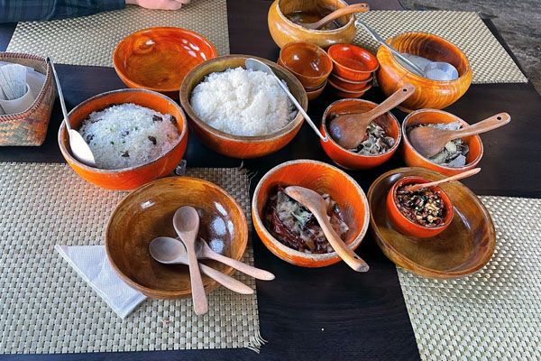 Varities of Bhutanese dish served in wooden bowl in Babesa Village restaurant